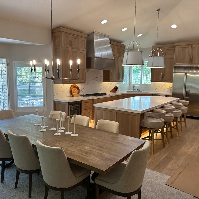 Residential kitchen brightly lit with new recessed and under-cabinet lighting installed by Landrock Electric